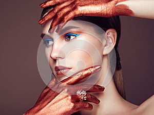 Portrait of beautiful young woman with art make-up