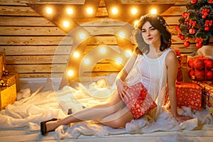 Portrait of a beautiful young woman on the background of a Christmas tree, the concept of new year holidays