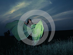 Portrait of a beautiful young woman on background of sunset