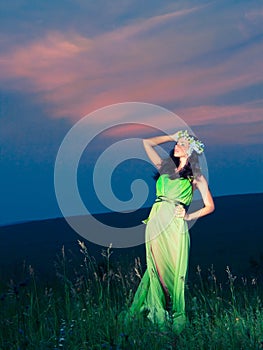 Portrait of a beautiful young woman on background of sunset