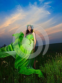 Portrait of a beautiful young woman on background of sunset