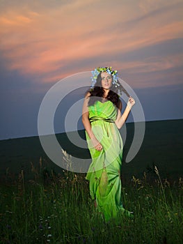 Portrait of a beautiful young woman on background of sunset