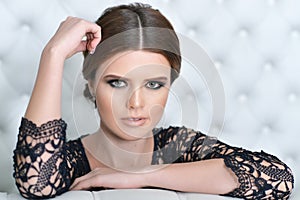 Portrait of beautiful young woman in bedroom