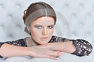 Portrait of beautiful young woman in bedroom