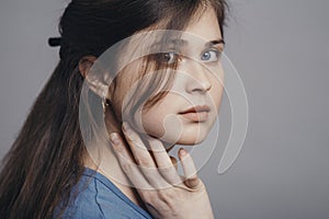 Portrait of a beautiful young woman with blue eyes on studio background, face of girl with natural beauty, concept people