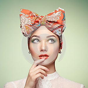 Portrait of beautiful young woman with bow