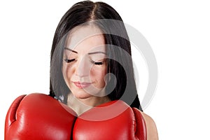Portrait of beautiful young woman with boxing gloves and closed