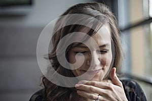 Portrait of Beautiful Young Woman with Brown Hair Laughing
