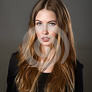 Portrait of beautiful young woman with brown hair and make-up