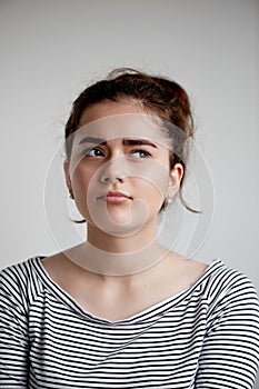 Portrait of a beautiful young woman brunette, natural make-up, expresses emotions think,believe, expect, suppose