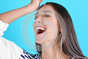 Portrait of beautiful young woman bursting into laughter photo