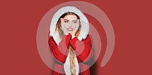 Portrait of a beautiful young woman celebrate winter Christmas holidays isolated on red background. Young beautiful girl