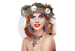 Portrait of beautiful young woman with Christmas wreath
