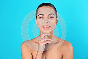 Portrait of beautiful young woman on color background