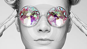 Portrait of beautiful young woman with colored glasses