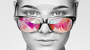 Portrait of beautiful young woman with colored glasses