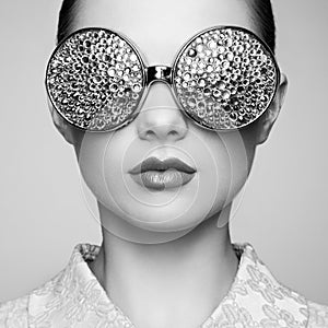 Portrait of beautiful young woman with colored glasses