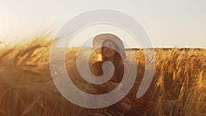 Portrait of beautiful young woman in a countryside field. Female face in the rays of sunset. Freedome and happiness.