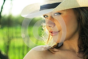Portrait of beautiful young woman cowgirl in hat