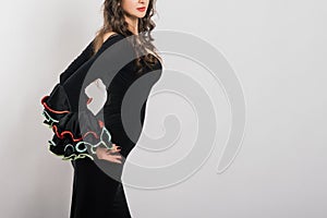 Portrait of beautiful young woman dancing flamenco in studio