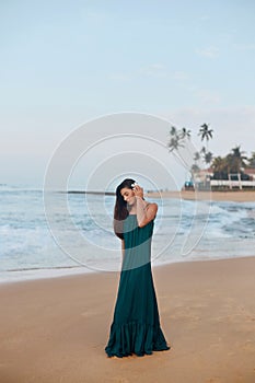 Portrait of beautiful young woman in dress on the beach. Pretty girl on tropical beach. Freedom concept, holiday, beach,