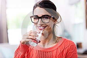 Portrait of beautiful young woman drinking water