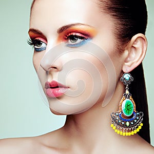 Portrait of beautiful young woman with earring. Jewelry and accessories