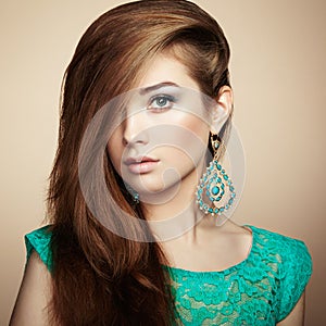 Portrait of beautiful young woman with earring. Jewelry and accessories