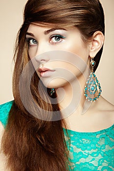 Portrait of beautiful young woman with earring. Jewelry and accessories