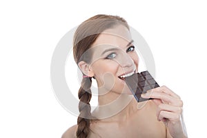 Portrait of a beautiful young woman eating a chocolate bar.