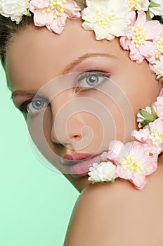 Portrait of beautiful young woman with flowers