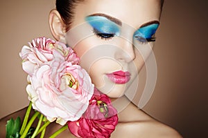 Portrait of beautiful young woman with flowers