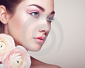 Portrait of beautiful young woman with flowers