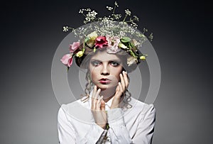 Portrait of beautiful young woman with flowers in hair