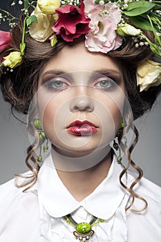 Portrait of beautiful young woman with flowers in hair