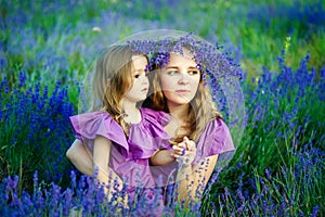 Portrait of beautiful young woman and her little daughter outdoor