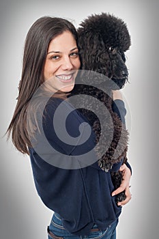Portrait of a beautiful young woman hugging her beautiful dog