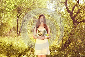 Portrait of beautiful young woman with lily of the valley