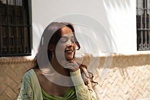 Portrait of a beautiful young woman with long hair. The woman is happy and is travel around the world. Travel and holiday concept