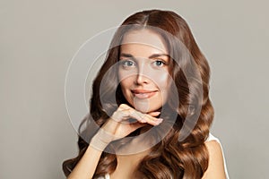 Portrait of a beautiful young woman with Long wavy hair, healthy clear skin and gentle smile