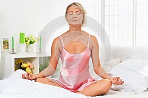 Portrait of beautiful young woman meditating morning