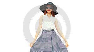 Portrait of beautiful young woman model posing wearing black summer straw round hat and striped skirt isolated on white background