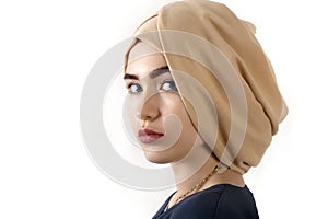 Portrait of a beautiful young woman in a muslim turban, over white background