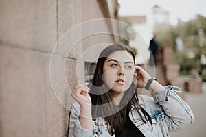 Portrait of a beautiful young woman with natural light outdoors in the city