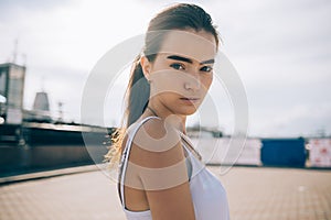 Portrait of beautiful young woman in the open urban space