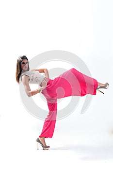 Portrait of a beautiful young woman in a pink dress on a white background