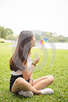 Portrait of beautiful young woman with pinwheel