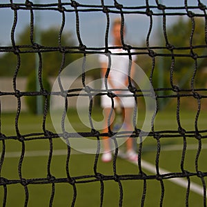 Portrait of beautiful young woman playing paddle tennis.