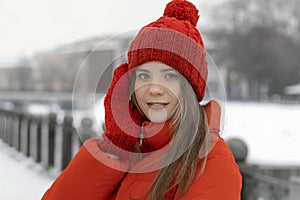 Portrait of a beautiful young woman in a red hat and coat