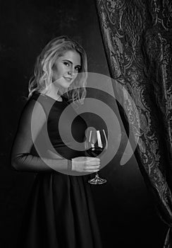 Portrait of beautiful young woman with red wine.